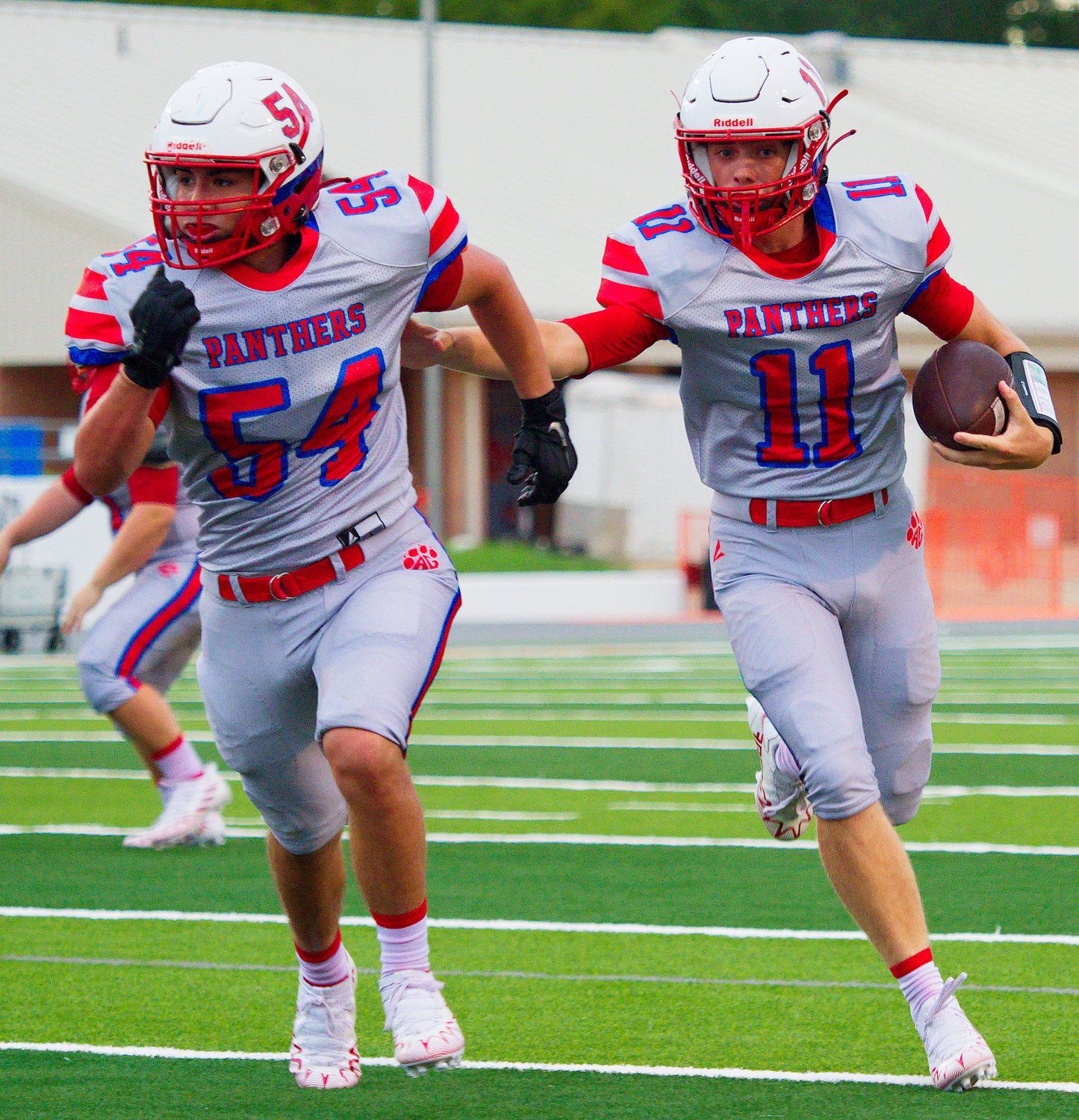 Easton Campbell, named first-team all-district quarterback, follows Tyler Perez to the endzone Aug. 25 facing Detriot in Mineola. [see more of the Panthers' memorable season]
